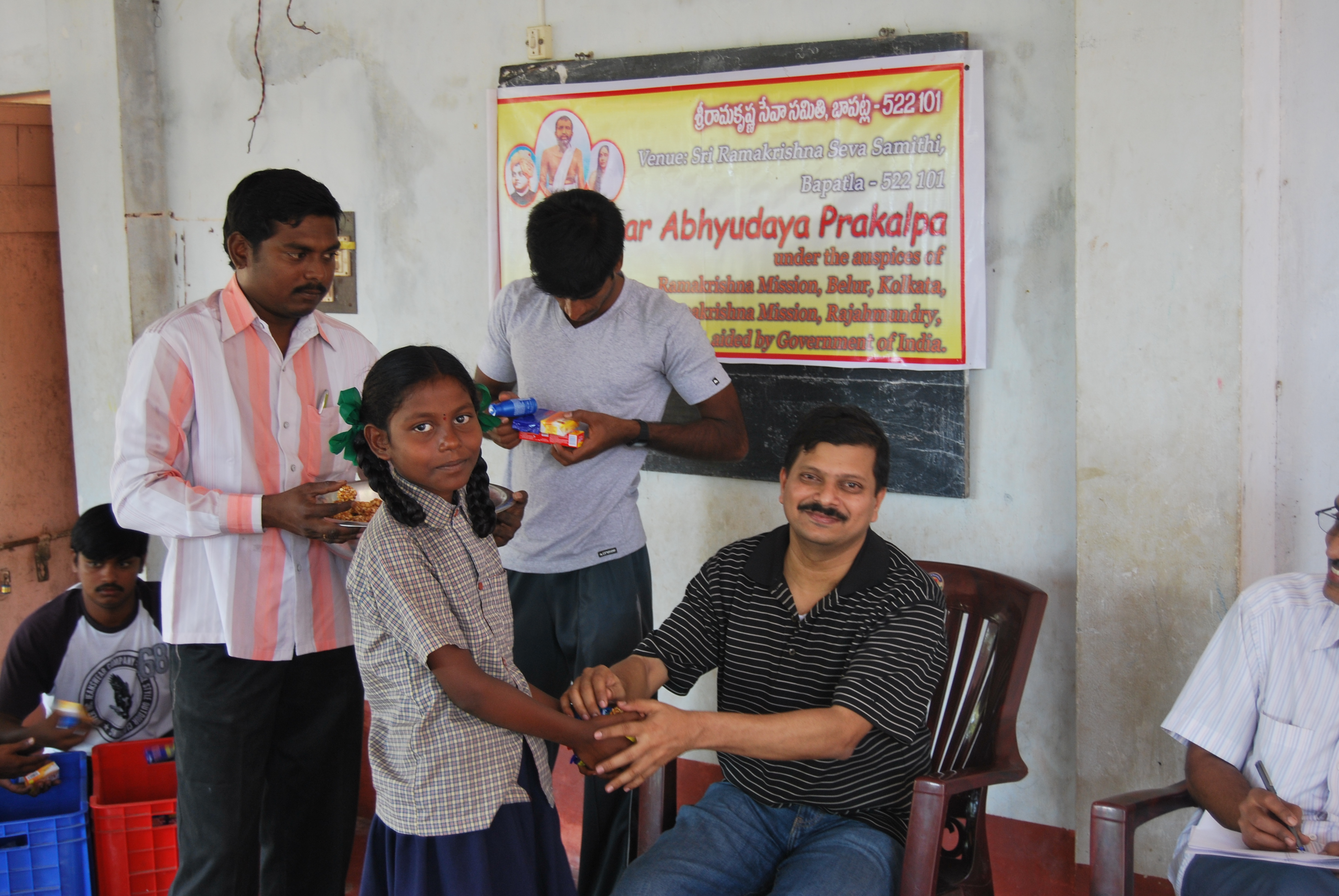 C Sridhar IAS giving away the monthly toiletries etc.