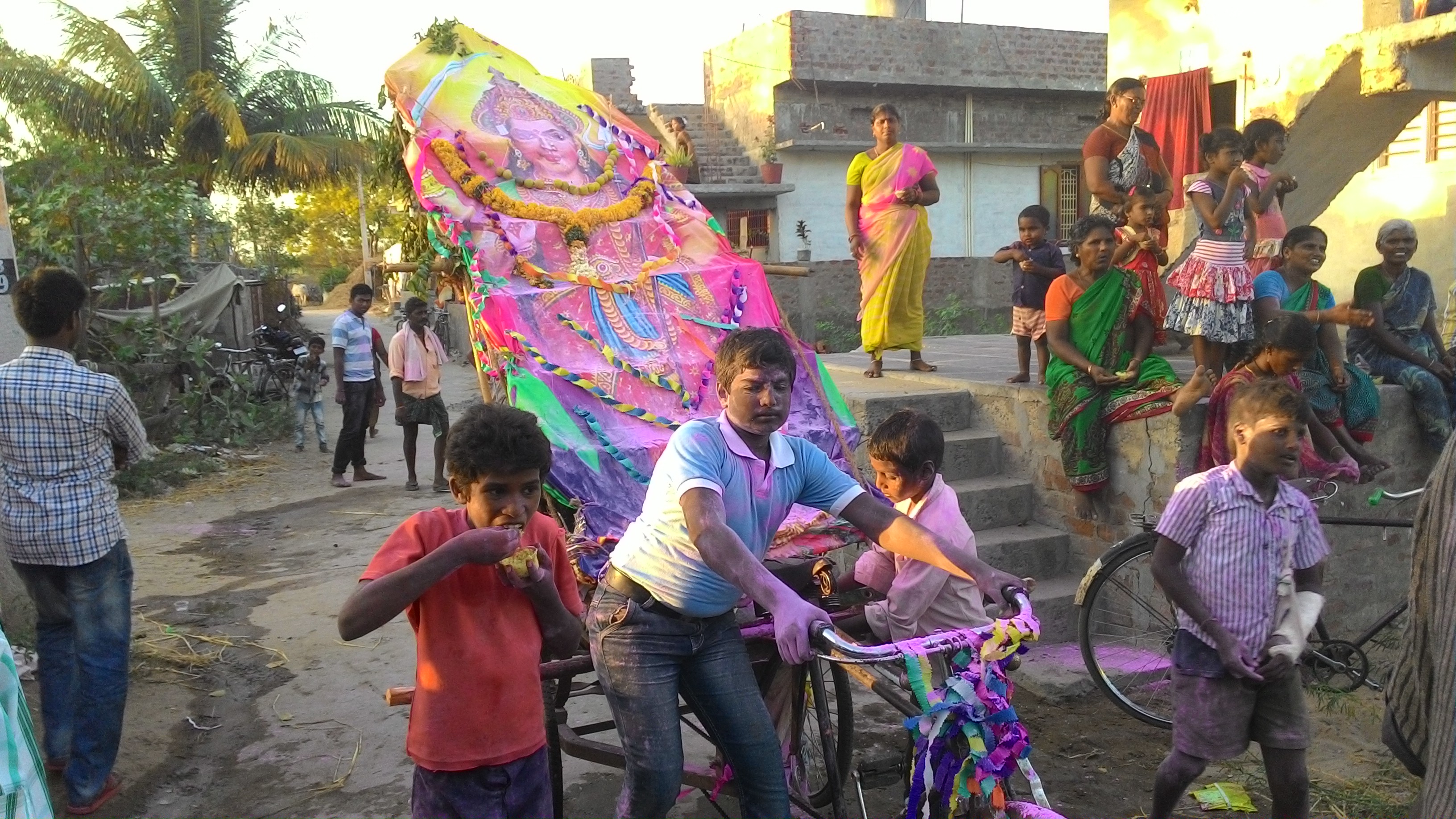 Some enthusiastic youngsters who prepared a second prabha and taking it on a rickshaw